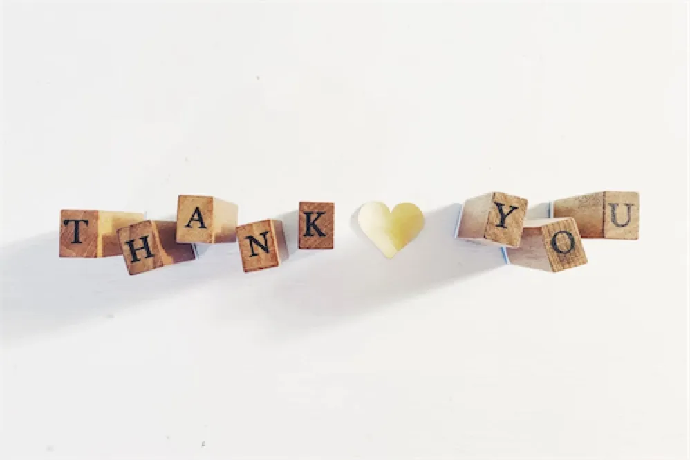 Wooden letter stamps spelling Thank You with a heart