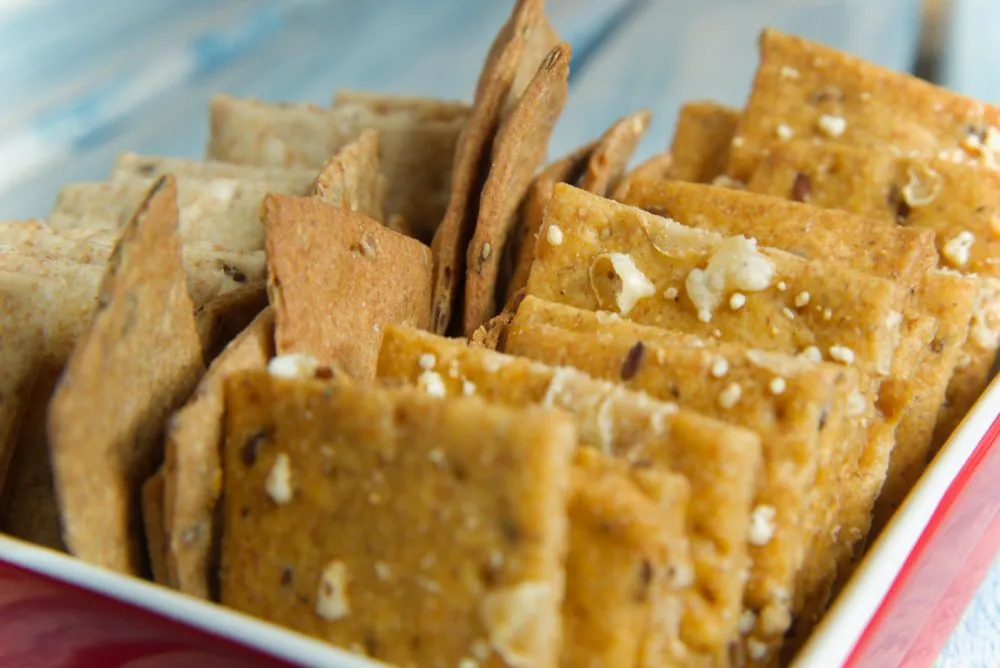 Seeded crackers in a red dish